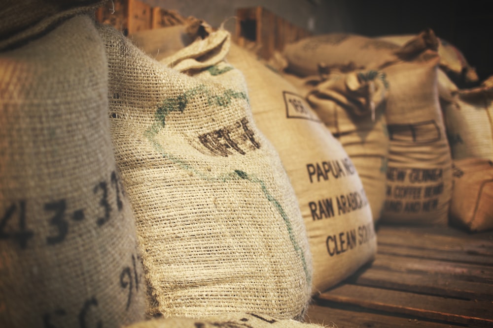 Stacked sacks of flour in a small mill warehouse with warm natural light